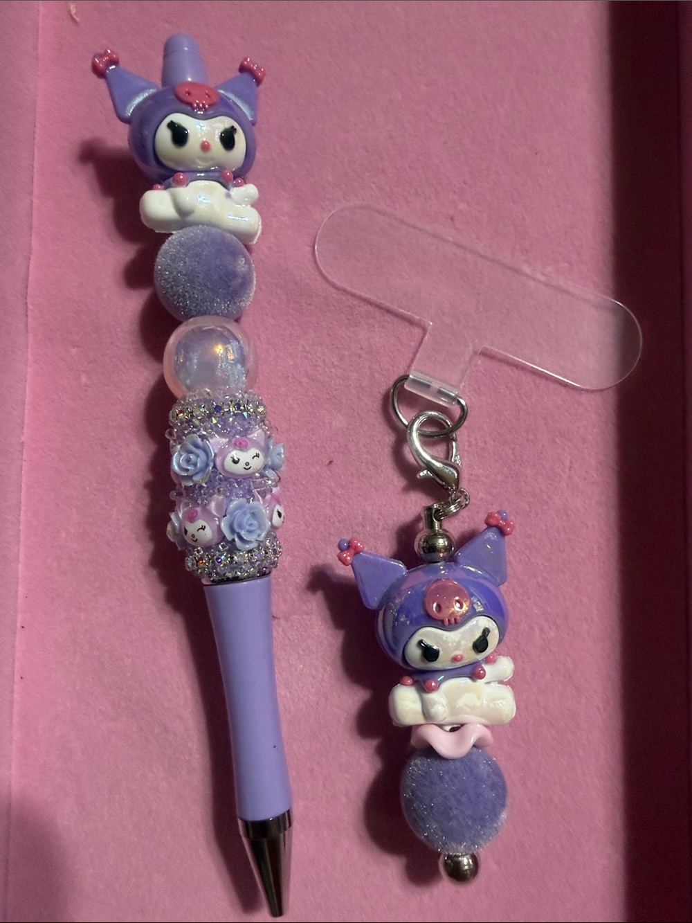 Purple beaded Kuku rhinestone pen with matching phone charm with attachment.